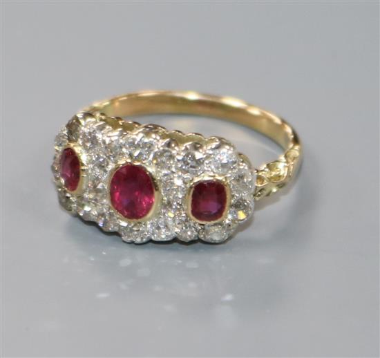 A yellow metal, ruby and diamond triple cluster ring, size O.